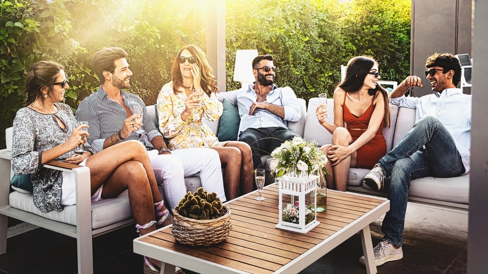 Group,of,cheerful,young,people,carefree,sitting,together,drinking,wine