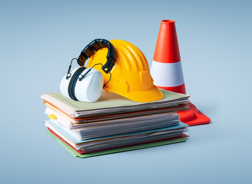 Pile,of,paperwork,,safety,equipment,and,work,tools:,construction,and