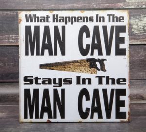 A,novelty,sign,for,the,man,cave,against,a,wood