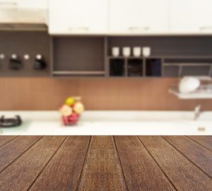 Wood,table,top,on,blur,the,background,of,the,kitchen.